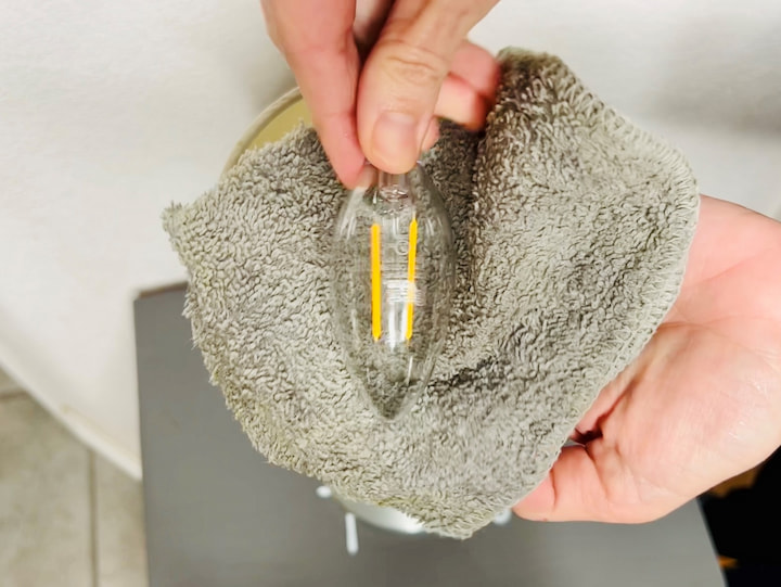 This next dusting hack works for any light bulb.  Simply take a damp washcloth and wipe off your light bulb.  You can also use a damp microfiber cloth as well. One thing that's important is to make sure that the light bulb has been off and cool before you touch it and don't turn it on right away you want to make sure it's completely dry before using it.  