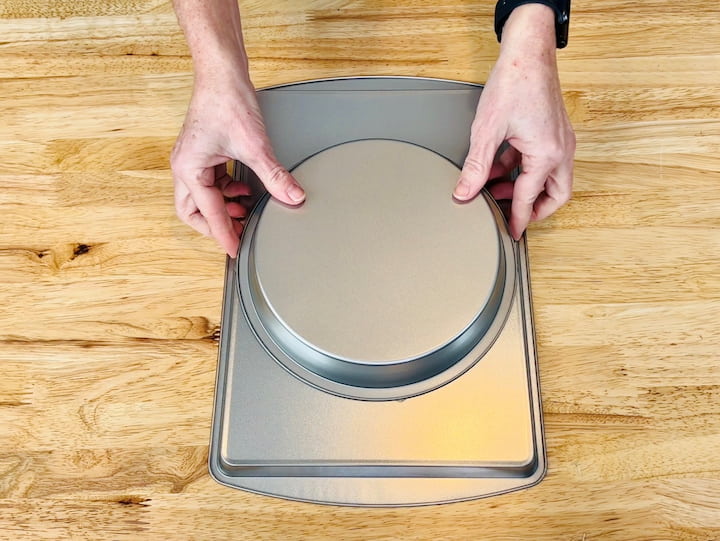 4. Place the adhesive cake pan onto the bottom of the baking sheet.