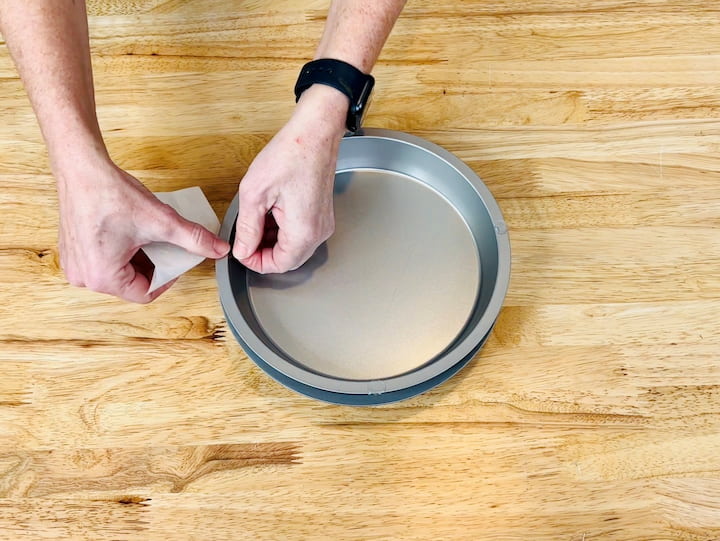 3.  Add adhesive to the edges of the top cake pan