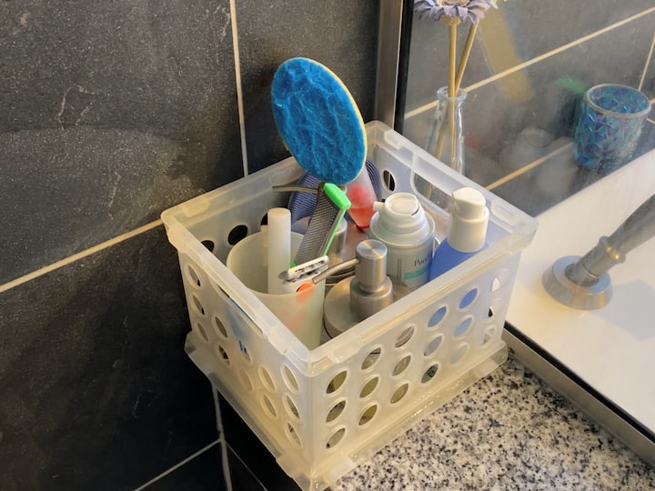 I use these plastic baskets in my shower as a bathroom organizer. They have holes underneath so the water drains through and then when it's time to clean I just pick them up and pull them out of my shower. It makes cleaning so much easier. 