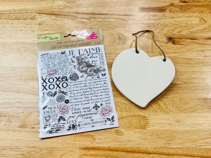 For this project, I'm using rub-on transfers and the ceramic heart that I found at Dollar Tree.