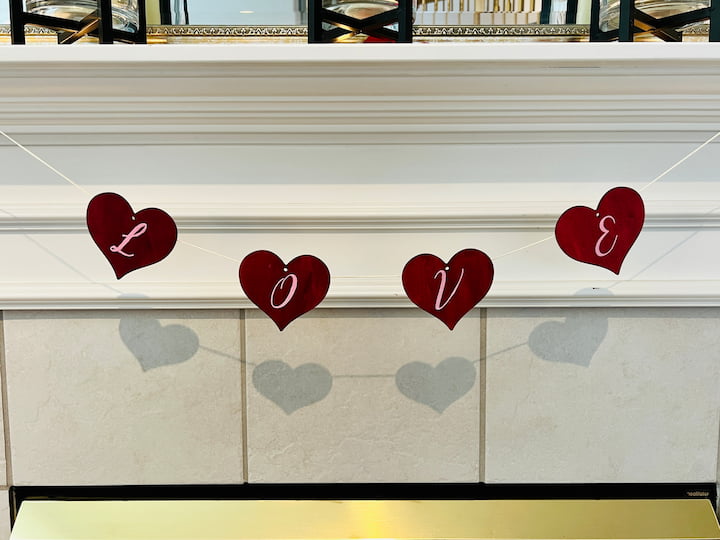I hot glued all my wooden Hearts to a little kite string and hung this by the mantel.
