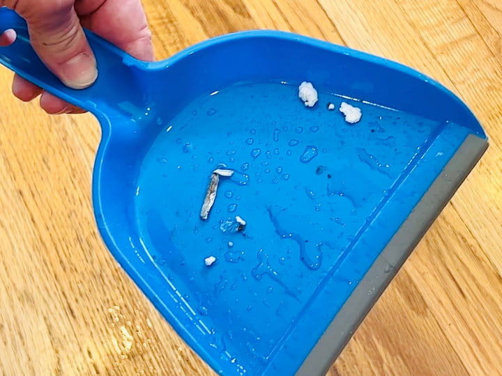 If you are using a broom pan here's a little hack. Sweep the dirt into a little pile, spray that broom pan with just a little bit of water sweep up the dirt onto the broom pan. What you'll find is all of that stuff will stick right onto the broom pan and you can go throw it away easily.