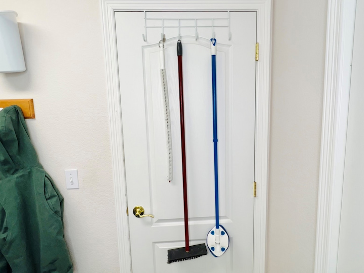Over-the-door hooks also work great for cleaning tools like mops or brooms or even umbrellas and purses that might otherwise be stored in a front hall closet.