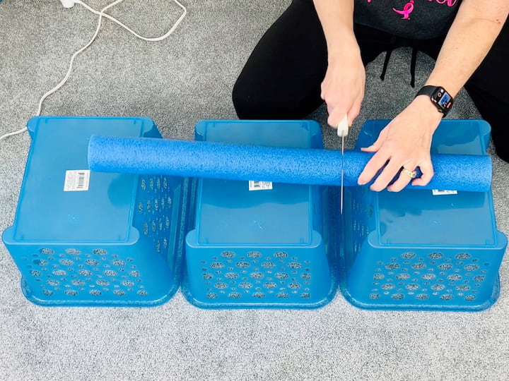 It is easiest to use a serrated knife, or something similar, to cut each of the pool noodles.  Place them in between each of the baskets.   