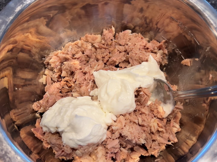 Add one container of plain non-fat Greek yogurt.  You can add as much or as little as you want, depending on your taste. Mix it all together.  