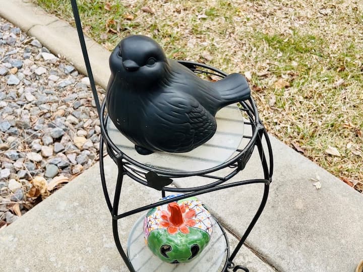 Here is a decorative ceramic bird that I have in my backyard. There's a hole in the bottom and I simply place the key inside and put the bird back on display. 