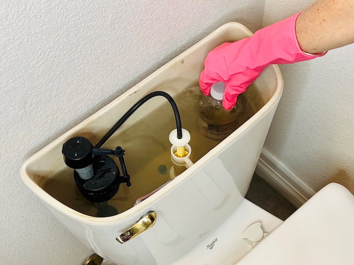 Place a full water bottle, vinegar bottle, etc into the tank of your toilet.  This bottle will fill up the space in your tank, and the tank will fill up with less water.  You'll be conserving water with every flush.