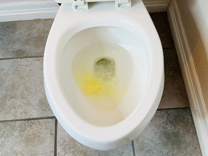 Mix baking soda, Kool-Aid, and rubbing alcohol together to form a ball. Place the toilet bomb into the toilet and watch it start to fizz. The baking soda is an abrasive cleaner, the rubbing alcohol disinfects, and the Kool-Aid makes it smell good. Scrub it all out and flush the toilet.