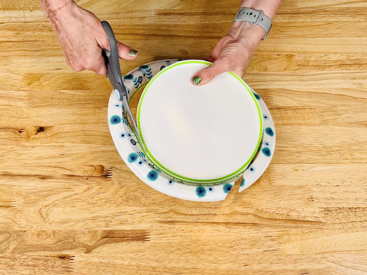 Cut the Inside Edge of a heavy-duty paper plate to fit inside the ice cream bucket.