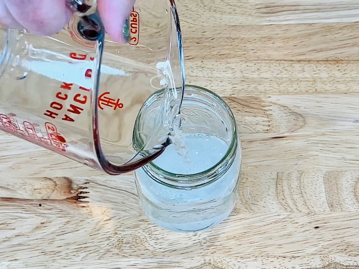 Fill the jar with one cup of water.