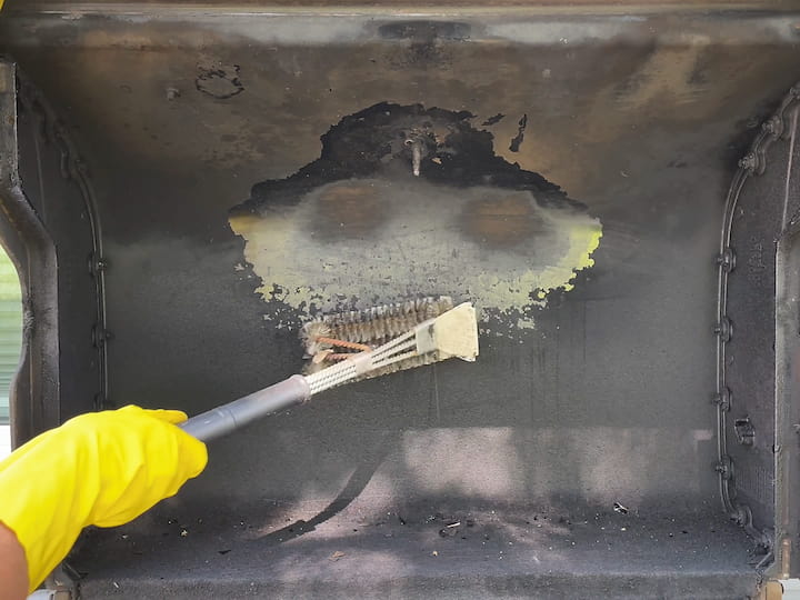 Removing Loose Particles: Using a grill brush (like a stainless steel bristle brush), we started scratching away at the loose pieces on the Weber grill. Both sides of the brush can be used to effectively remove residue. You could alternatively use steel wool.