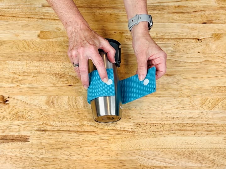 Create a heat-resistant grip for your coffee mug by cutting a section of yoga mat, adding adhesive Velcro to both ends, and wrapping it around your mug.