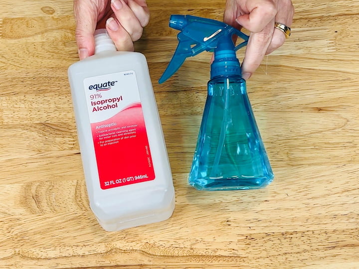 If you don't want to mix the cleaning solution, you can make a quick yoga mat cleaner by using rubbing alcohol. Look for a strong isotropic rubbing alcohol and pour it into a spray bottle. Spray it onto your yoga mat and then use a washcloth to wipe it off.