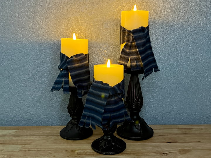 Now, you have a set of beautifully bundled candles with their snug fabric scarves, ready to bring winter charm to your home decor.
