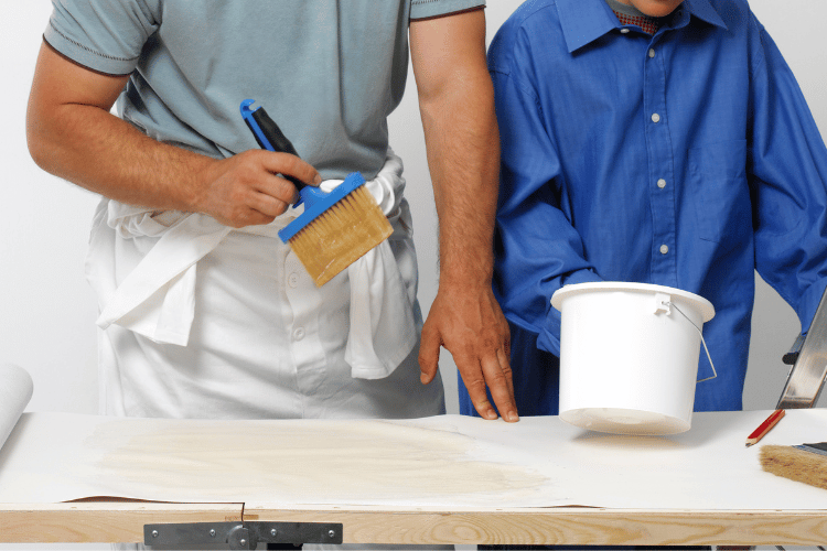 A man applying glue on HDPE sheets