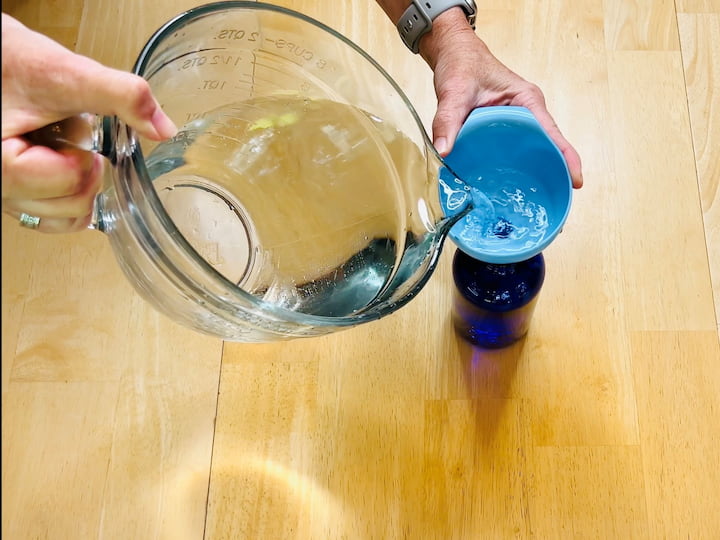 1. Mix the water, vinegar, and rubbing alcohol in a bowl. Avoid adding dish soap. 2. Use a funnel to pour the mixture into a spray bottle. 3. This spray is perfect for spot cleaning and can be used on a variety of surfaces. Just avoid using it on porous materials like granite.
