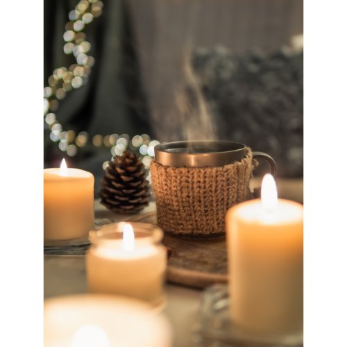 Candles are magical when it comes to setting a cozy mood. Scatter an assortment of candles around the room – on coffee tables, shelves, or window sills. Opt for various sizes and scents to create a relaxing ambiance that envelops your senses. The gentle flicker of candle light instantly adds warmth and cozy vibes to your space.