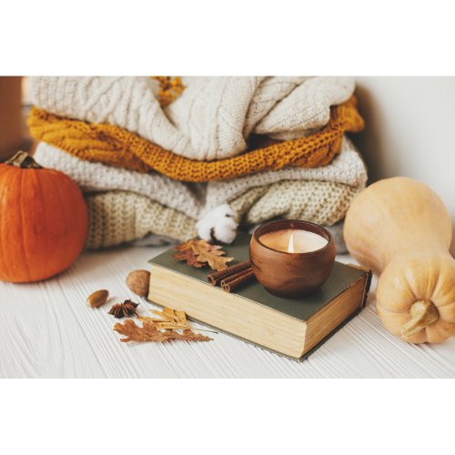 Choosing warm colors like greys and warm neutrals can instantly infuse your space with a sense of comfort. Rotate seasonal decor like pumpkins and seasonal recipes during the fall and winter months to keep your decor fresh and in tune with the time of the year.