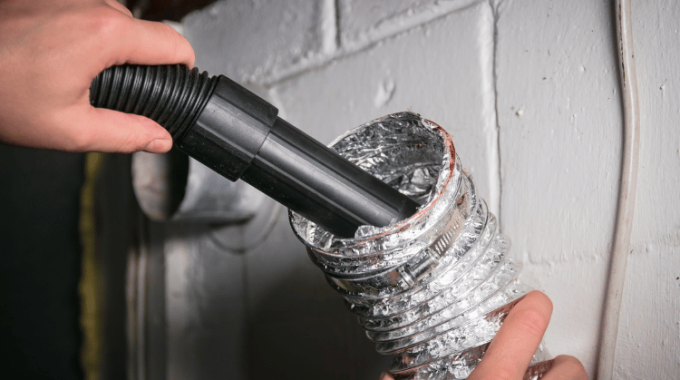 Vacuum cleaning a flexible aluminum dryer vent hose, to remove lint and prevent fire hazard