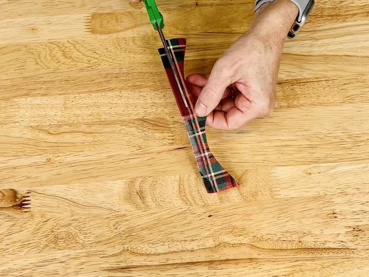 Cut a small rectangle from a scrap and wrap it around the bow's center.