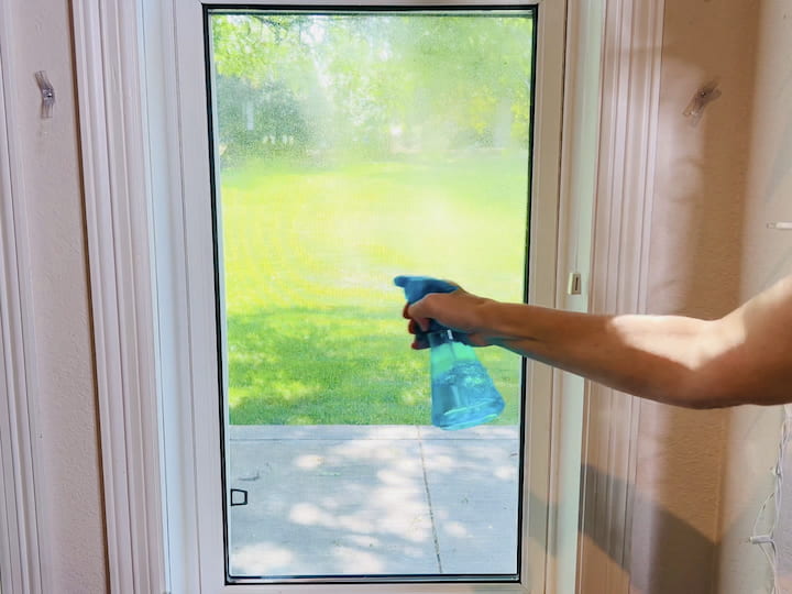 Spray your window with water or rubbing alcohol.Apply bubble wrap to the moistened window; it will stick in place.Optionally, use painter's tape for added support.