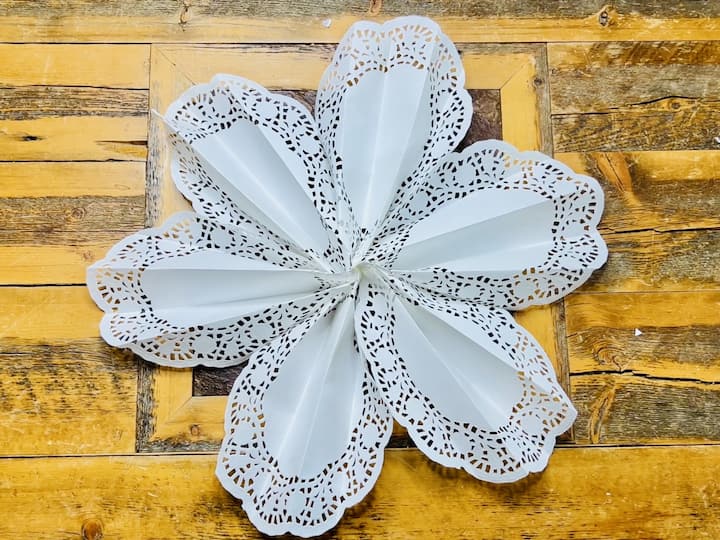 Quick Look at the Finished Product: Once all six doilies are securely attached, step back and admire your finished giant snowflake. Revel in the intricate design and impressive size of your DIY creation.