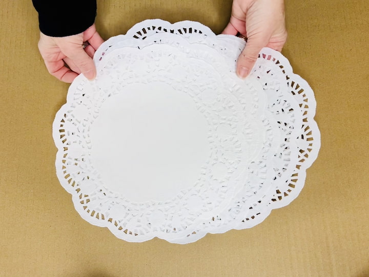 Select Doilies: Choose six large doilies for creating a grand and impressive giant snowflake.