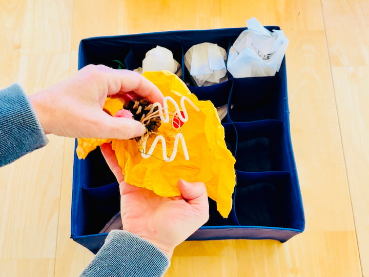 wrapping ornament with tissue paper