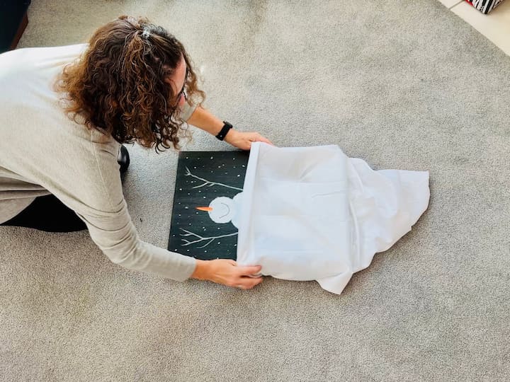 Chas packing artwork with a dollar store pillow case