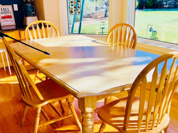 Now we're going to go ahead and move into the kitchen and you can start by spraying the kitchen table. Make sure to get all of those surface. We collect a lot of germs on that. In addition to that, you can always hit all of your chairs.