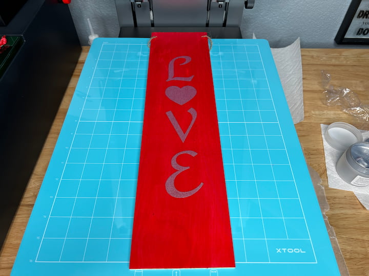 I created a custom design in xTool Creative Space for my sign. I painted the sign with Folk Art Ultra Dye, and let it dry. I screen printed the design on the sign.