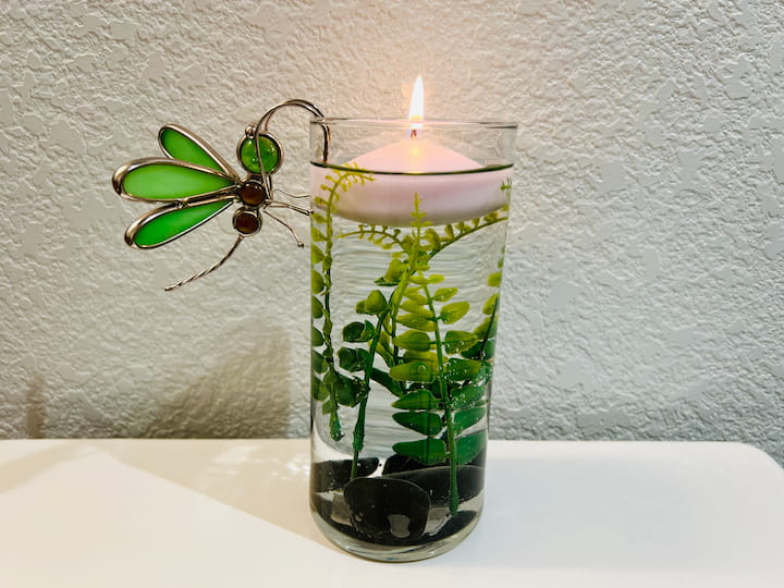 finished dragonfly craft with lit floating candle