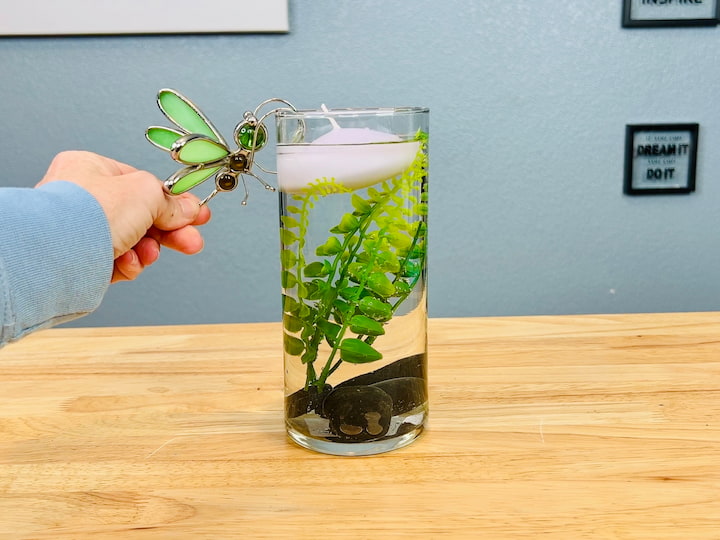 hanging dragofly on side of vase 