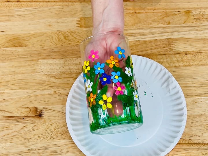 overhead shot of finished painted flower craft vase with yellow, white, light, orange and blue flowers