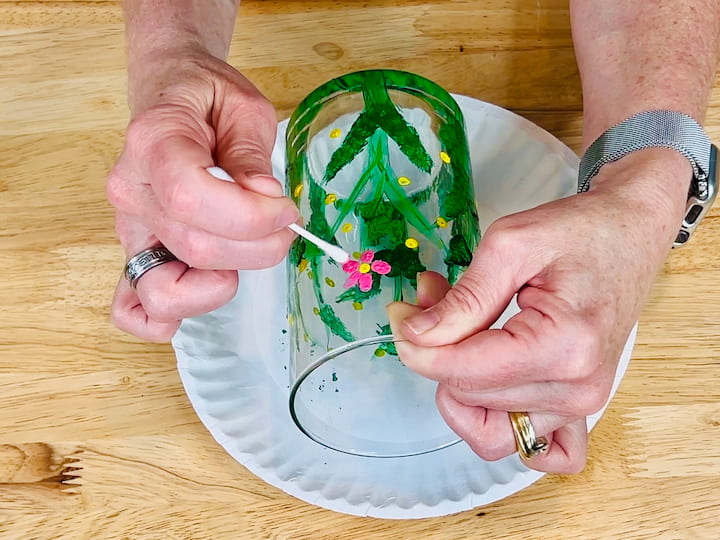 overhead shot of pink flower petals painted on flower craft vase with qtip