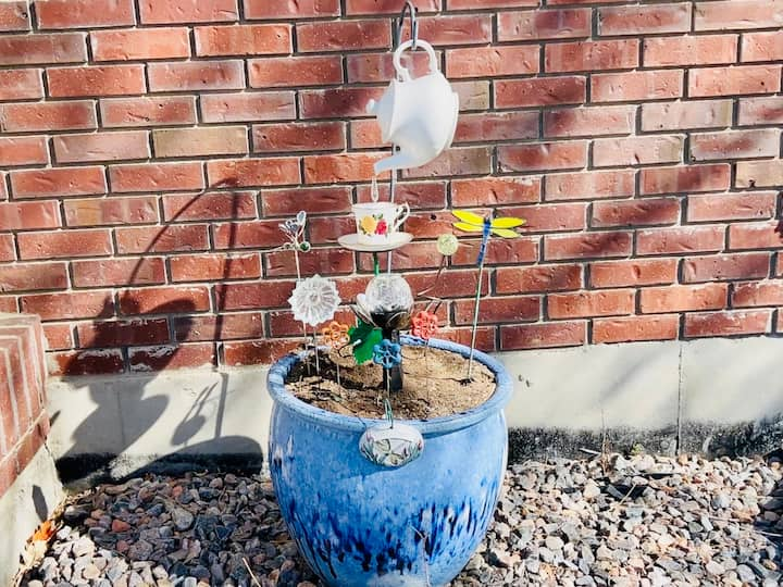 finished flower pot garden decor project with solar flowers complete