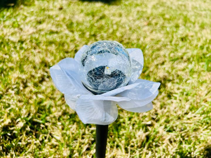 Finished solar flower with petals glued onto solar light.