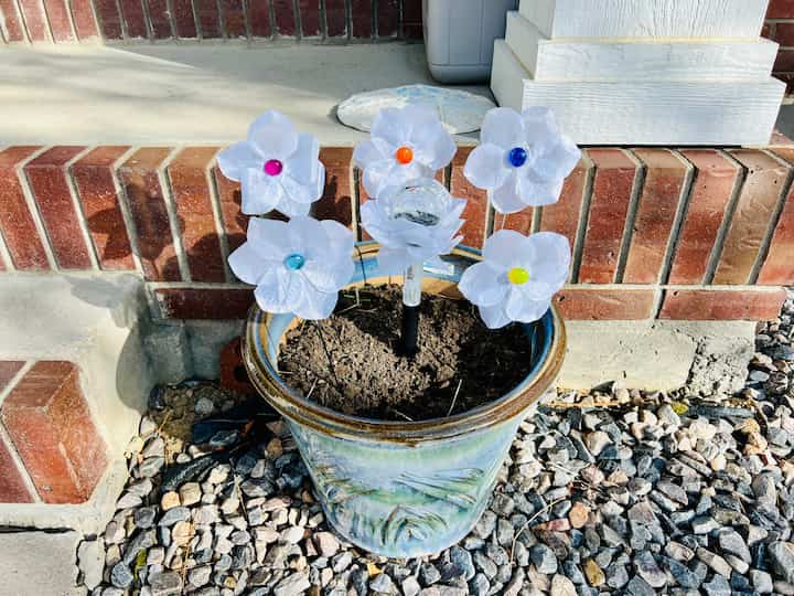 The two smaller flower pots on my entryway of DIY yard art.