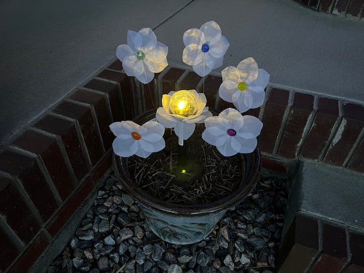 finished solar light flowers are lighting up all of the other flowers 