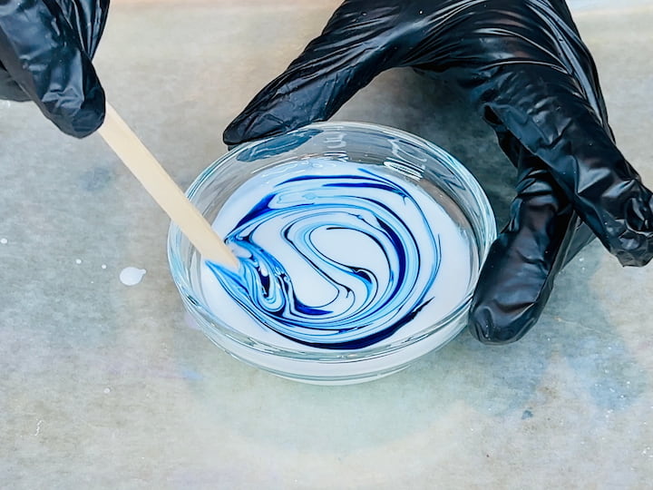 gloves and wooden stick to demonstrate how to mix Mod Podge and food coloring