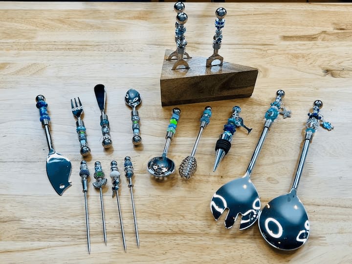 Look at all of these items for your kitchen and entertaining: salad tongs, wine stoppers, honey and olive scoop, items for appetizers, cheese cutters, and other serving utensils.