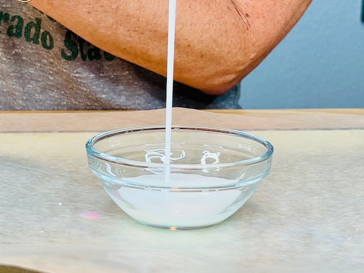 Mod Podge pouring into bowl for diy