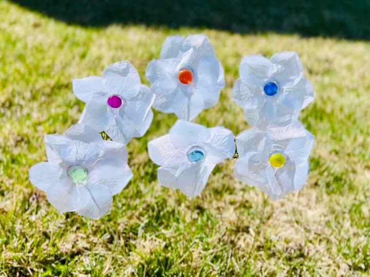 I went ahead and made several more of these flowers. I placed different glass gems in the center of all of them. Now you can use different colored petals if you want, mix and match, or you could even dye these with a little food coloring.