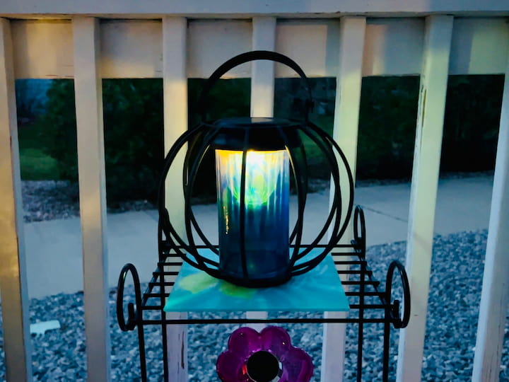 Here is the soft glow of the painted vase solar light at dusk.