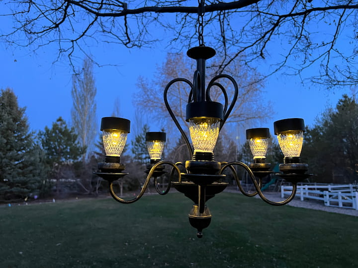 Here it is at night. I love this one and the beautiful glow it has. I love using solar chandeliers in an outdoor dining area.