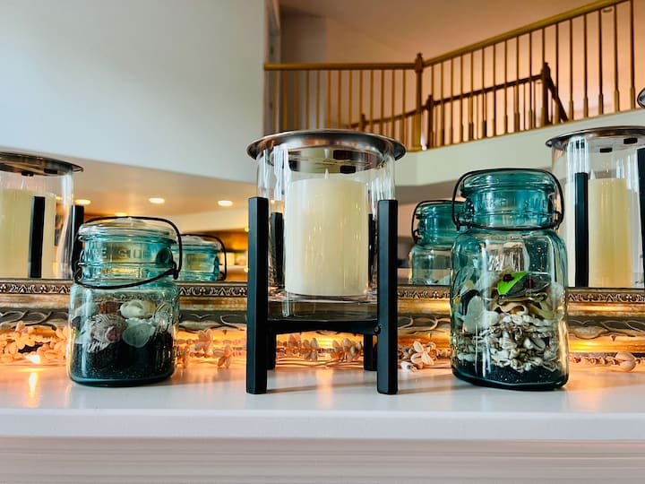 summer fireplace decor with seashells, mason jars and candles