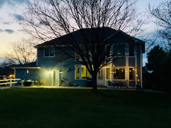 view of summer backyard lit with patio lights