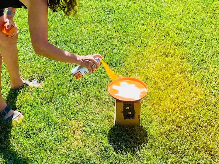 I took two of the burner covers outside, and I spray painted one orange, and the second one I spray painted with green spray paint.