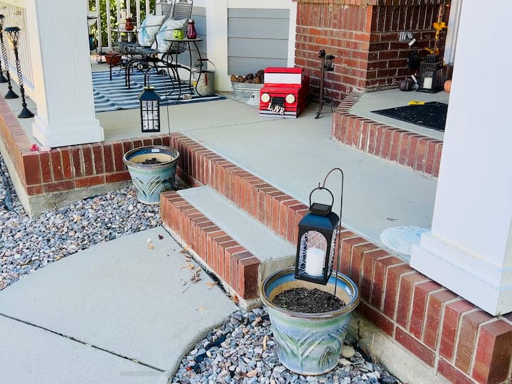 I grabbed some smaller shepherd's hooks and placed them into my flower pots in my front yard, and then I placed the lanterns on the shepherd's hooks. You can see the cobwebs on the lanterns during the day. 